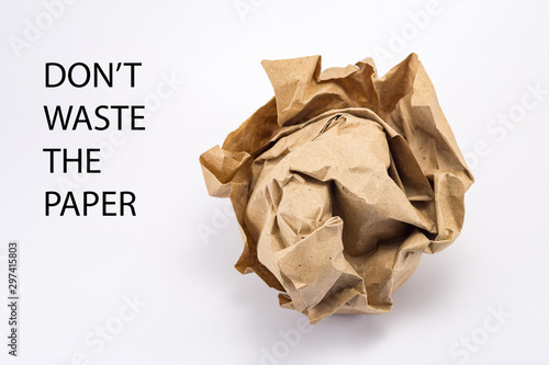 crumpled into a lump craft paper isolated on white background with inscription don’t waste the paper, forest conservation concept