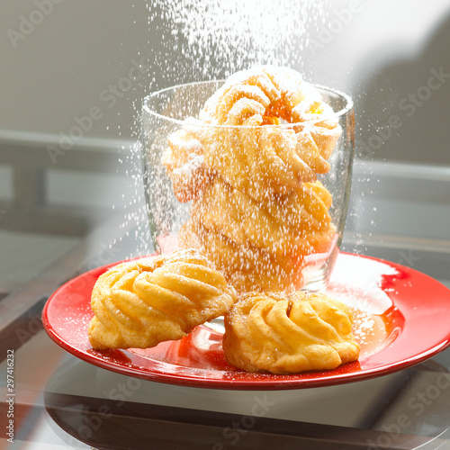 pastries being dusted with powdered sugar