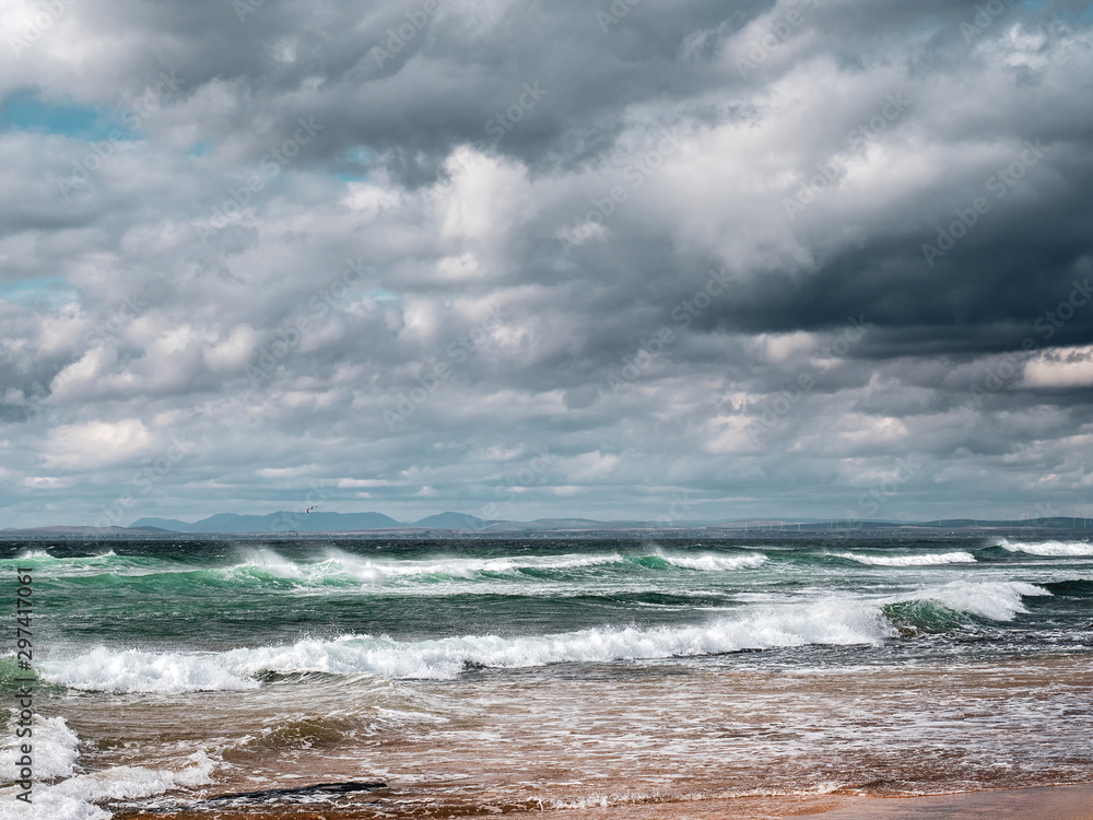 Atlantic ocean, dramatic sky, Waves rushing towards the coast. Fanore beach, county Clare, Ireland.