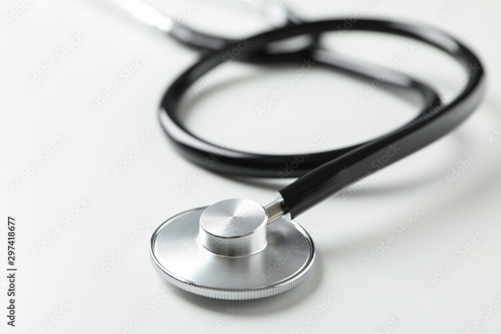 Black stethoscope on white background, close up. Healthcare Black stethoscope on white background, close up. Healthcare