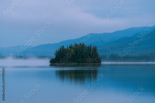 Sunrise during autumn season with reflections on lake in Alaska