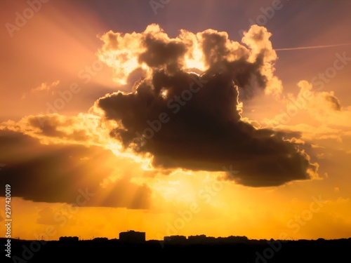 Dramatic Cloudscape with isolated sunrays around cloud