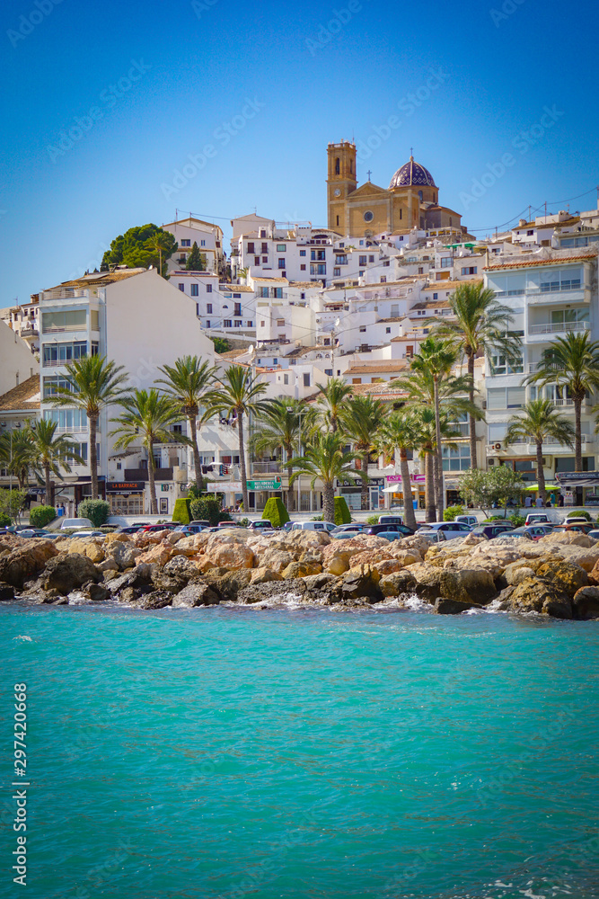 ALTEA, SPAIN - OCTOBER 4, 2019: Beautiful houses in Altea with tourist attractions and turquoise sea