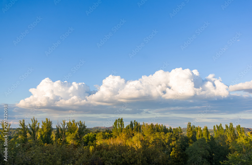 Obraz premium Autumn urban landscape on a Sunny day - yellow autumn trees and bright sky with clouds