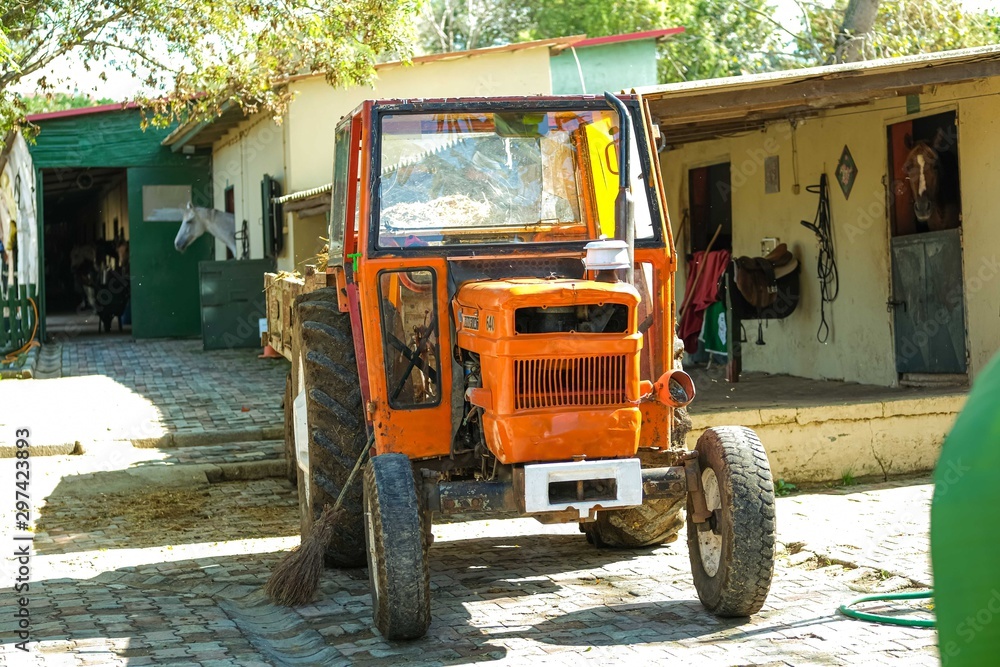 Obraz premium Old orange rusty farm tractor.
