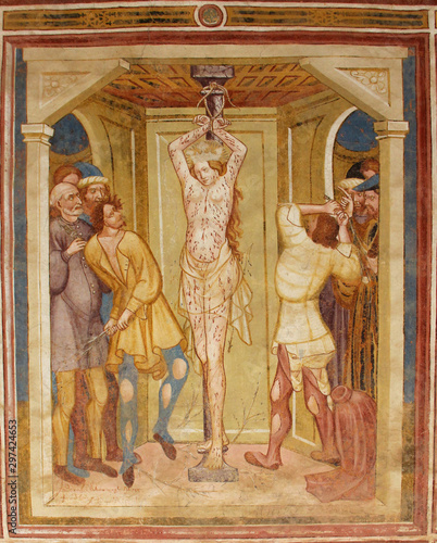 l'Imperatore Massenzio fa flagellare Caterina. Storie di Santa Caterina d'Alessandria; affresco esterno della  chiesa di Santa Caterina a Breien (Val di Tires, Bolzano) photo