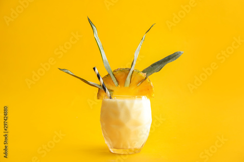 Glass of tasty Pina Colada cocktail on color background