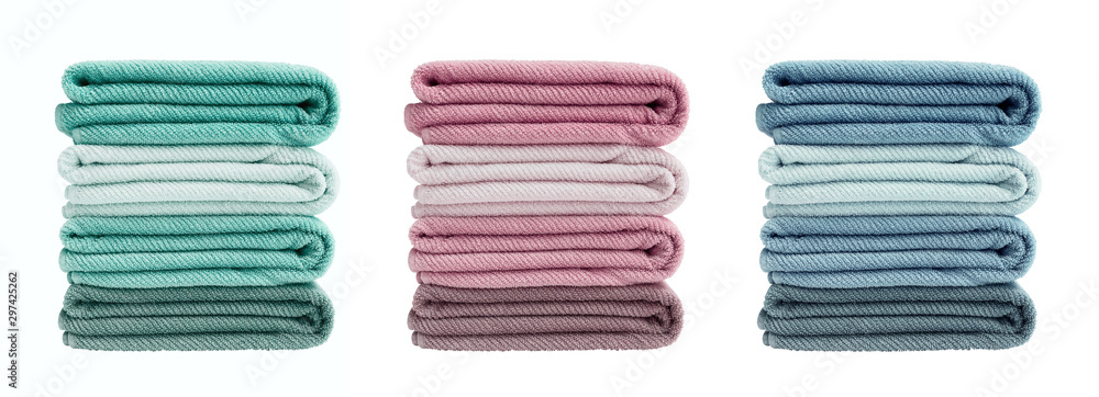 Set of colorful bath towels isolated over white background. Bath towels in stack - obrazy, fototapety, plakaty 