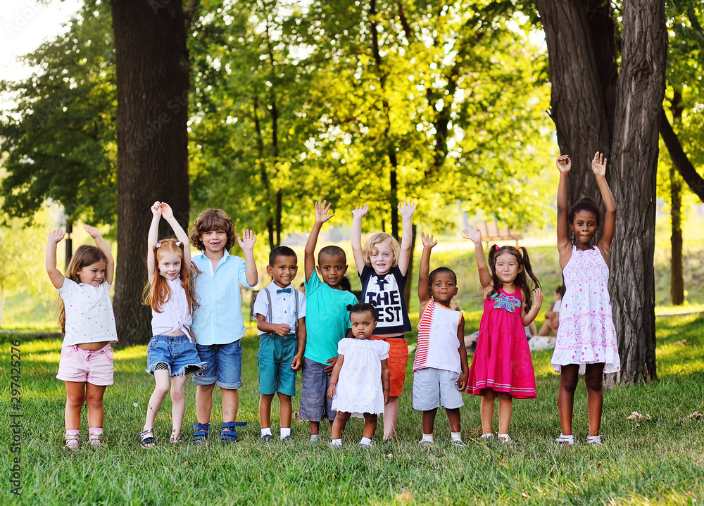 many young children of different races play together in the Park on the green fresh grass. The concept of ethnic friendship of different peoples. many young children of different races play together in the Park on the green fresh grass. The concept of ethnic friendship of different peoples.