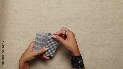 Young Woman Shuffles Tarot Cards Close Up