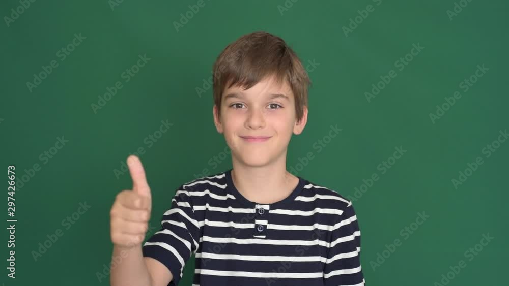 Young boy with thumb up on the green screen Young boy with thumb up on the green screen