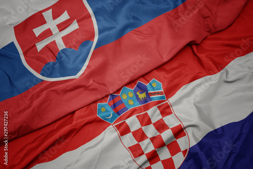Photography waving colorful flag of croatia and national flag of slovakia.