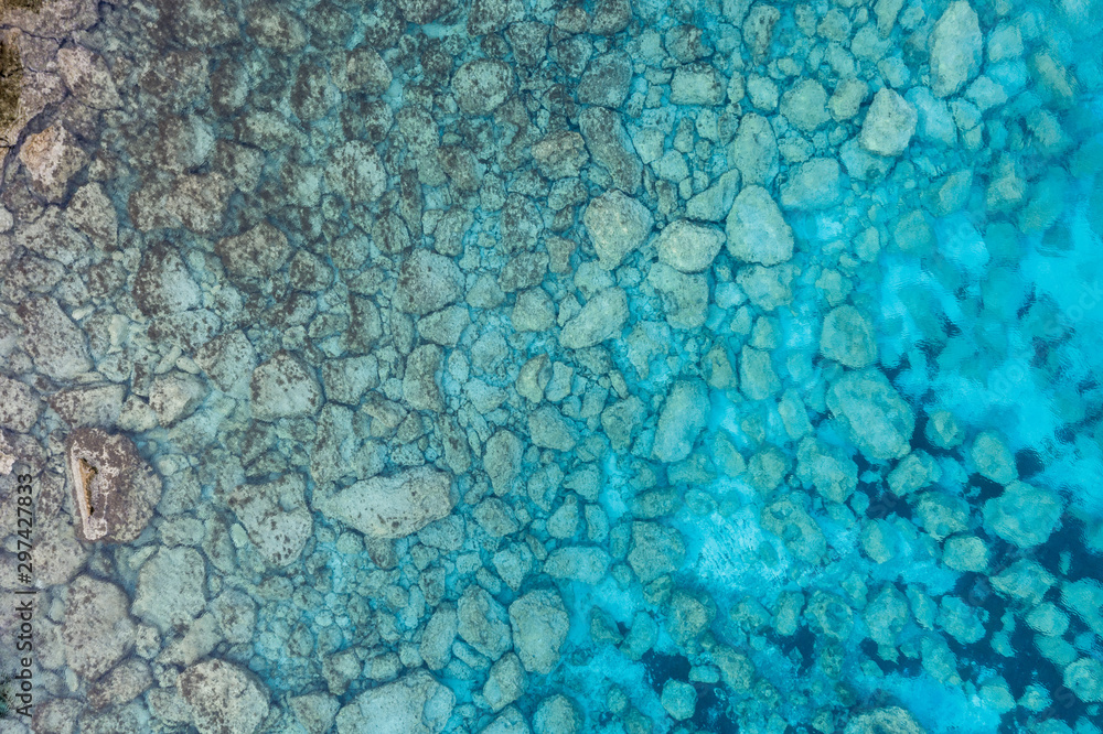 An aerial view of the beautiful Mediterranean sea, where you can se the rocky textured underwater corals and the clean turquoise water of blue lagoon Agia Napa An aerial view of the beautiful Mediterranean sea, where you can se the rocky textured underwater corals and the clean turquoise water of blue lagoon Agia Napa