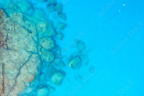 An aerial view of the beautiful Mediterranean sea  where you can se the rocky textured underwater corals and the clean turquoise water of blue lagoon Agia Napa