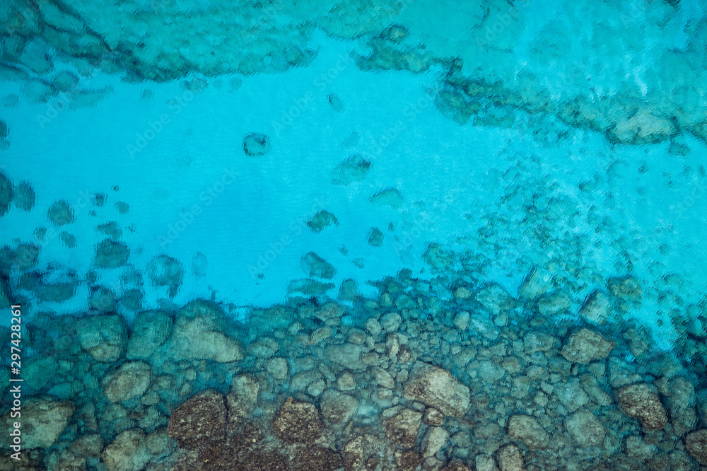 An aerial view of the beautiful Mediterranean sea, where you can se the rocky textured underwater corals and the clean turquoise water of blue lagoon Agia Napa An aerial view of the beautiful Mediterranean sea, where you can se the rocky textured underwater corals and the clean turquoise water of blue lagoon Agia Napa