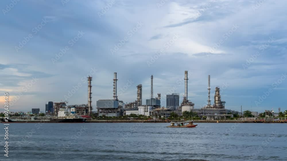 Oil refinery petrochemical and energy industry with refection on river, day to night - Time-lapse Oil refinery petrochemical and energy industry with refection on river, day to night - Time-lapse