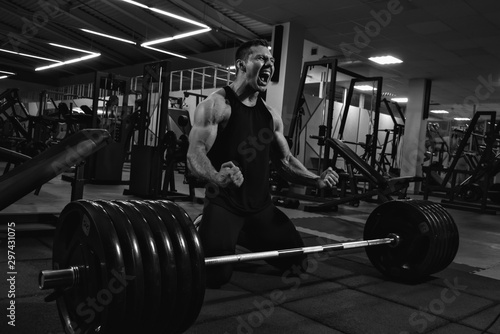 Young man powerlifter after deadlift