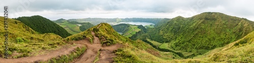 Panoramic view from the Miradouro da Grota do Inferno viewpoint at Sete Cidades on São Miguel in the Azores. The Lagoa Azul is in the background with a mud dirt footpath leading towards the distance.