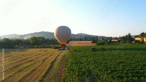 Aerial Drone Footage: Hot Air Balloon Flying Over the Beautiful Fields and Plantation with Mountains in the Background