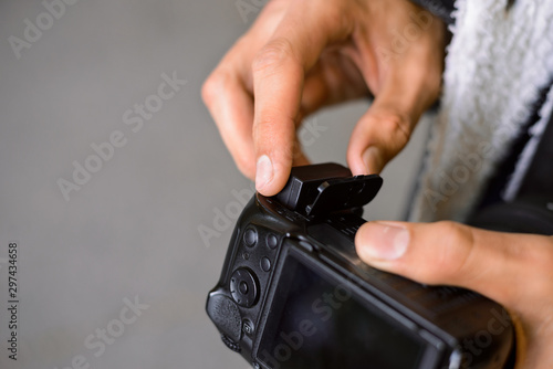 Photographer changing battery in his dslr camera outdoot whole shooting
