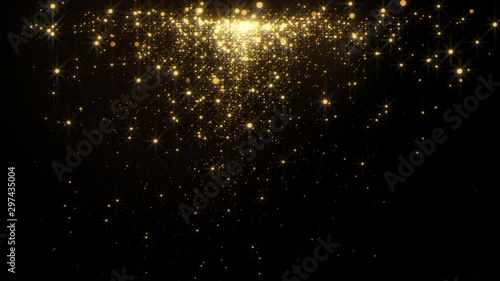 Fiery golden glowing star-like particles falling down over black background. photo