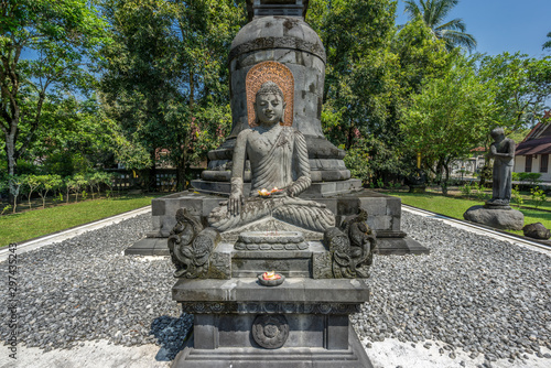 Buddha stone statue in the Bhumisparsha Mudra or gesture. Mendut Buddhist Monastery (Vihara Mendut). Located next to Mendut Temple, Mungkid Town, Central Java. photo