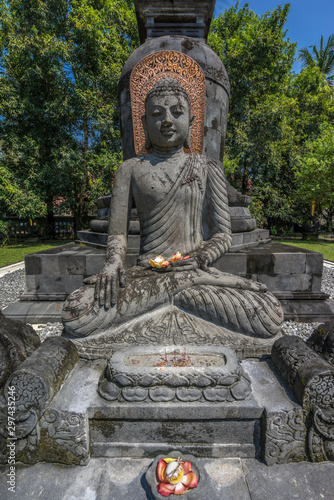 Buddha stone statue in the Bhumisparsha Mudra or gesture. Mendut Buddhist Monastery (Vihara Mendut). Located next to Mendut Temple, Mungkid Town, Central Java. photo