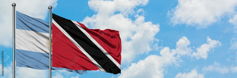Argentina and Trinidad And Tobago flag waving in the wind against white cloudy blue sky together. Diplomacy concept, international relations. Argentina and Trinidad And Tobago flag waving in the wind against white cloudy blue sky together. Diplomacy concept, international relations.