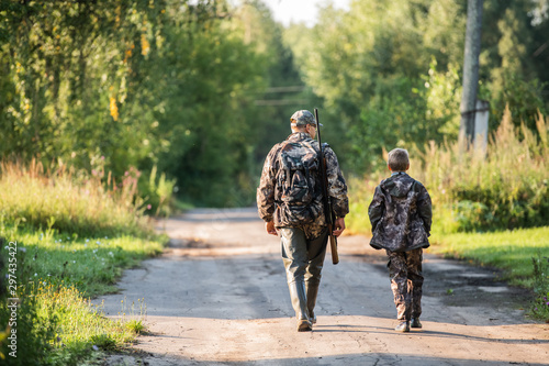 father pointing and guiding son on first deer hunt