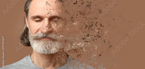Crumbling mature man on color background. Process of aging