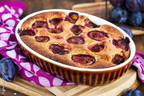 Fresh homemade dimply plum cake on rustic background