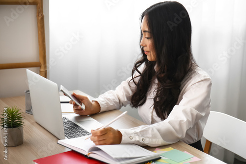 Young Asian woman working i...