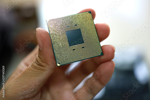 ็Hand holding microprocessor.
