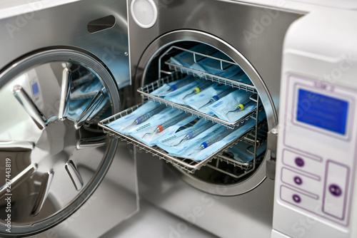 Photos Sterilize machine with opened door and dental probes inside