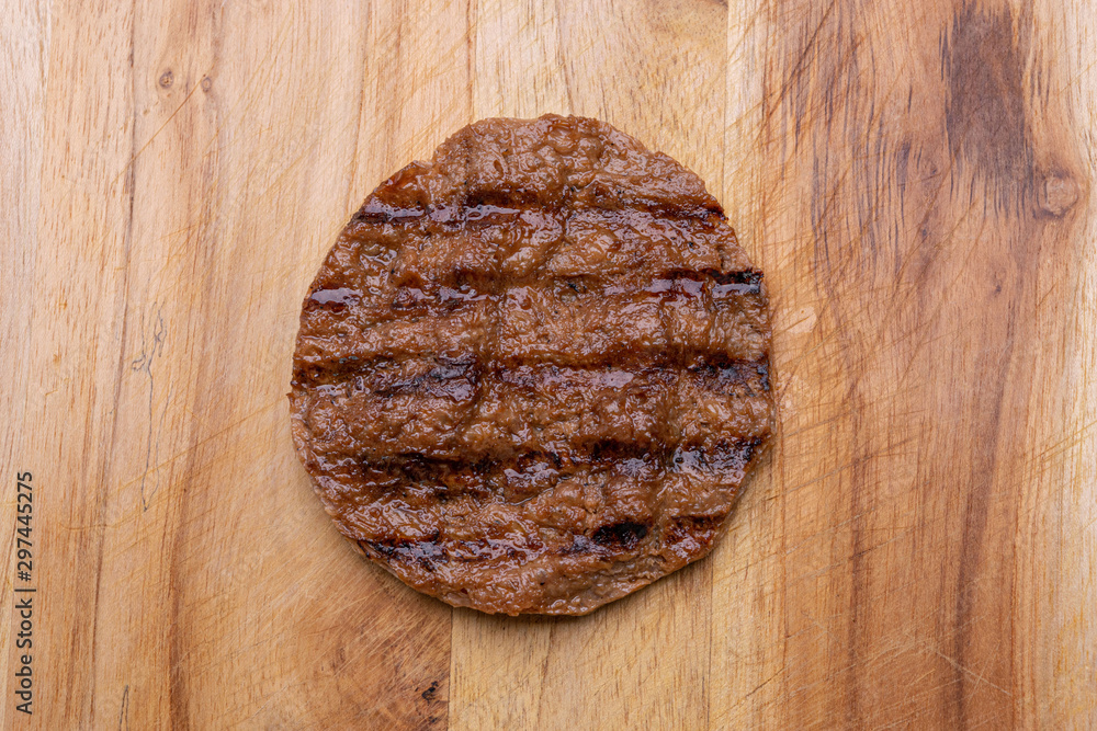 Vegan patty isolated on wooden background Vegan patty isolated on wooden background