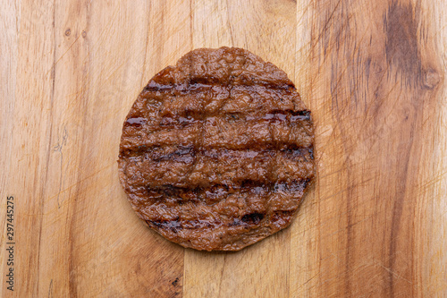 Vegan patty isolated on wooden background