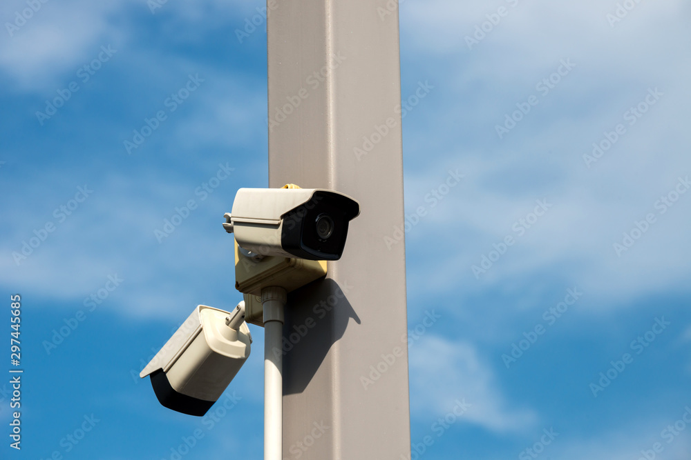 White CCTV security camera for home protection privacy security against crime surveillance mounted on house exterior Concrete poles. White CCTV security camera for home protection privacy security against crime surveillance mounted on house exterior Concrete poles.