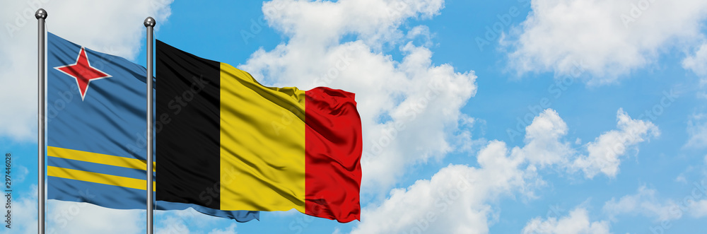 Aruba and Belgium flag waving in the wind against white cloudy blue sky together. Diplomacy concept, international relations. Aruba and Belgium flag waving in the wind against white cloudy blue sky together. Diplomacy concept, international relations.