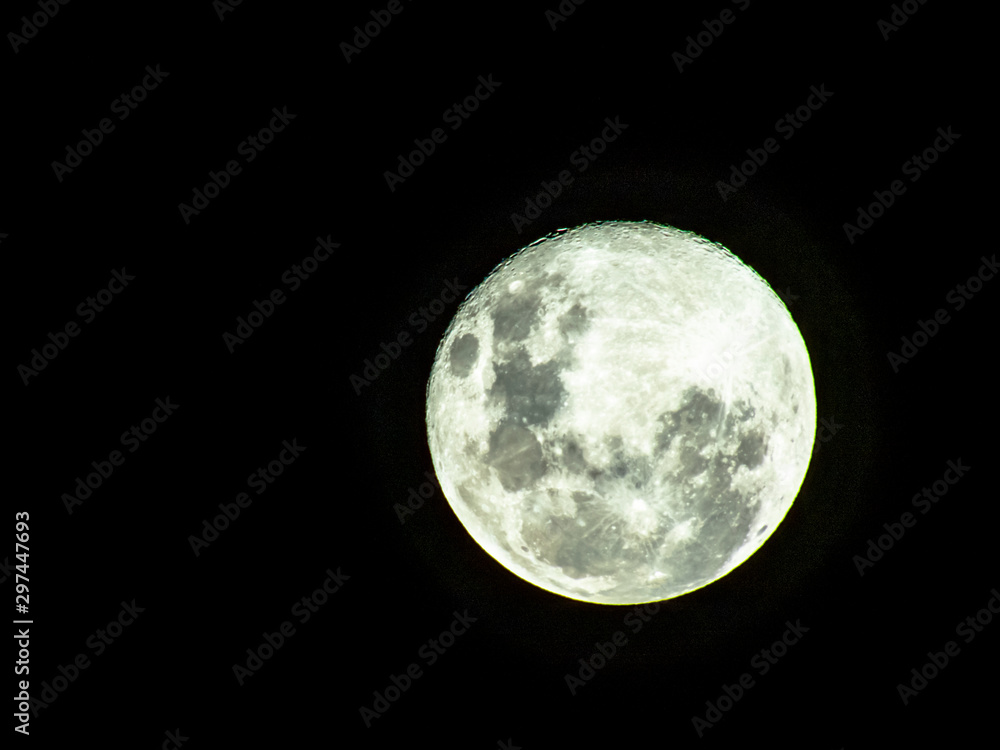 Obraz premium Moon in the middle of its way on the clear sky.