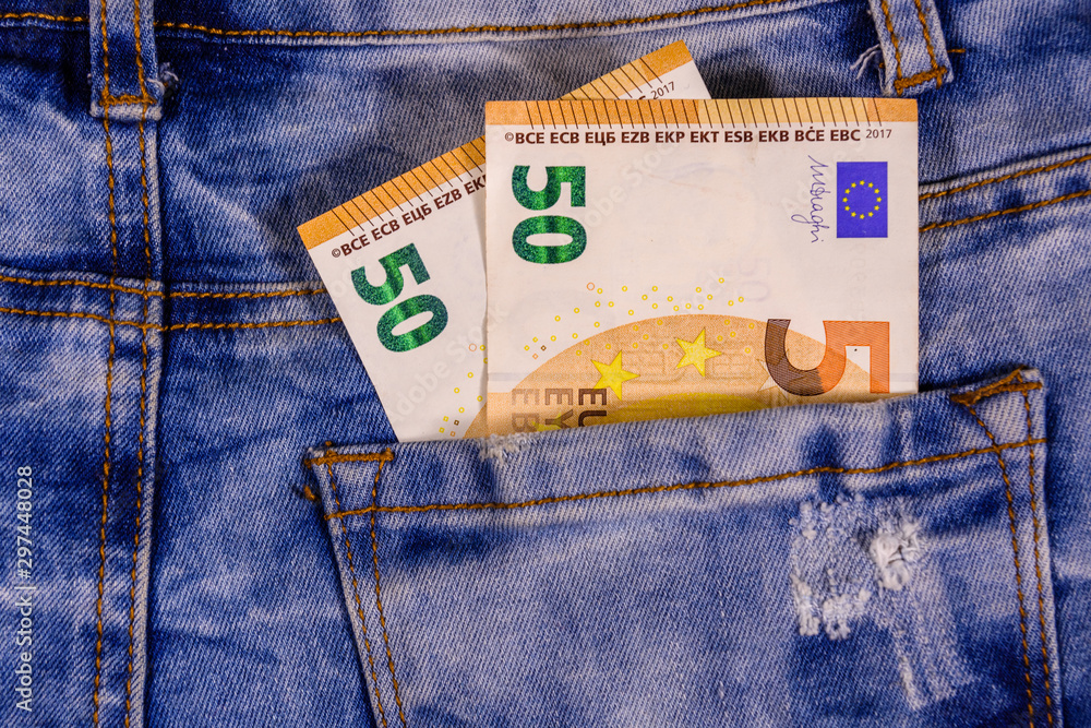 Fifty euro banknotes in pocket of the blue jeans Stock Photo | Adobe Stock