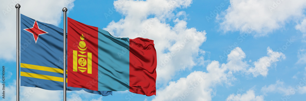 Naklejka premium Aruba and Mongolia flag waving in the wind against white cloudy blue sky together. Diplomacy concept, international relations.