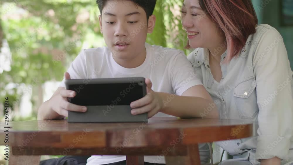 Mother and Son using digital tablet together, Mother and Son using digital tablet together,