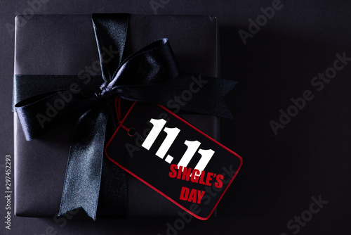 Online shopping of China, 11.11 single's day sale concept. black and red paper tag with ribbon on black background with copy space for text 11.11 single's day sale.