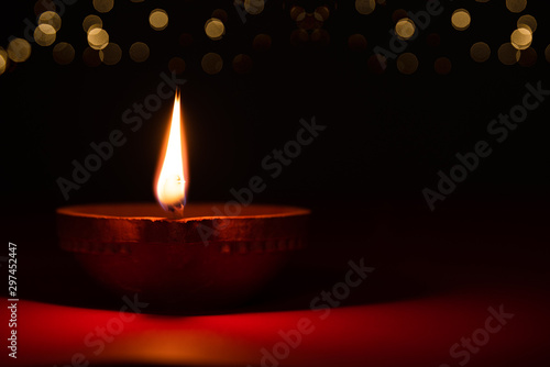 Happy Diwali - Clay Diya lamps lit during Dipavali, Hindu festival of lights celebration