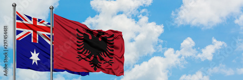 Australia and Albania flag waving in the wind against white cloudy blue sky together. Diplomacy concept, international relations.