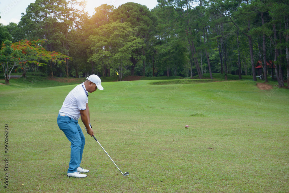 Fototapeta premium Golfer playing golf in beautiful golf course in the evening golf course with sunshine