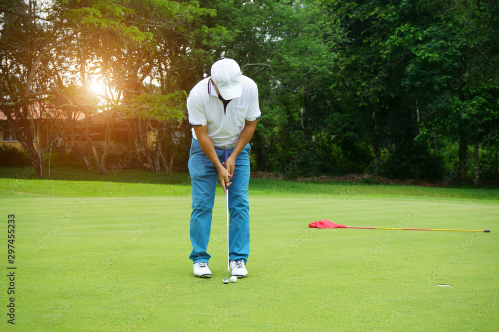Fototapeta premium Blurred golfer playing golf in beautiful golf course in the evening golf course with sunshine in thailand