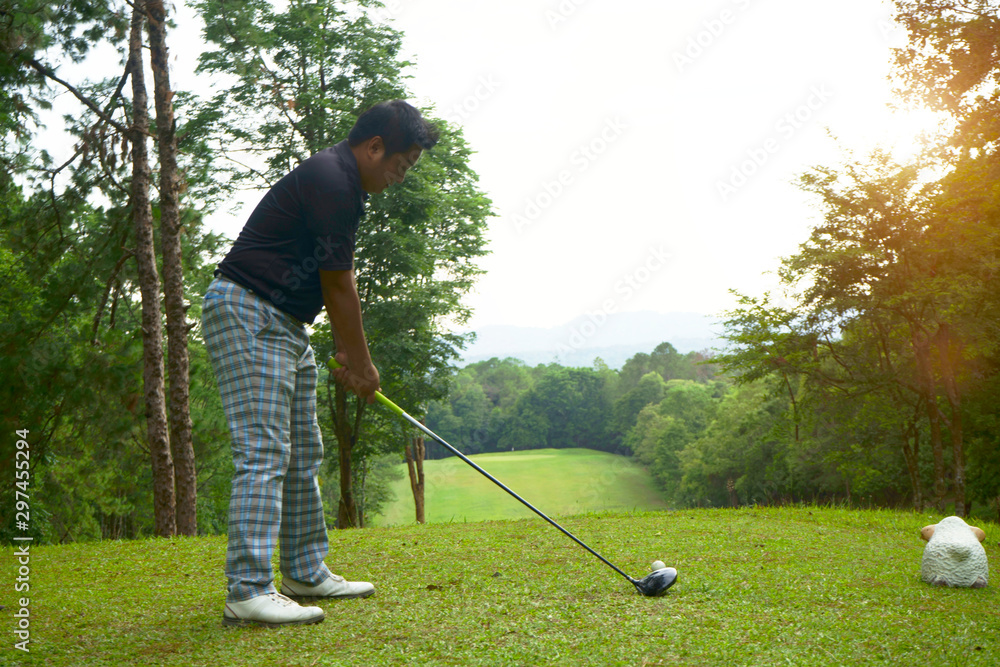 Fototapeta premium Blurred golfer putting golf in beautiful golf course in the evening golf course with sunshine in thailand.