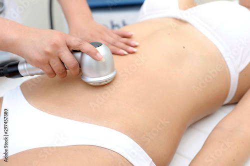 Cosmetology. Closeup Of Beautician Doing Laser Epilation Treatment On Beautiful Female Body, Removing Hair On Silky Skin.