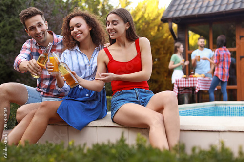 Photography Happy friends with drinks at barbecue party near swimming pool outdoors